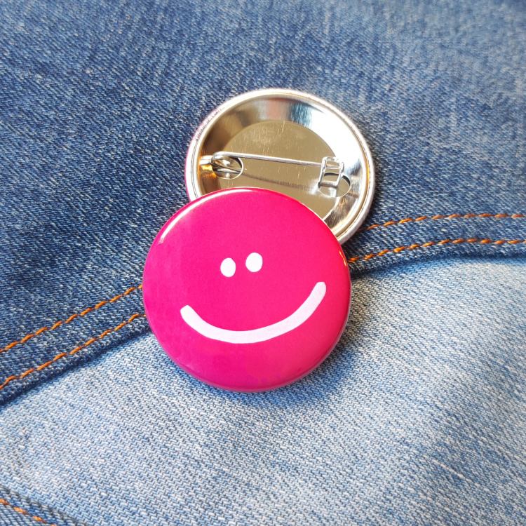 Ansteckbutton Smiley pink auf Jeans mit Rückseite